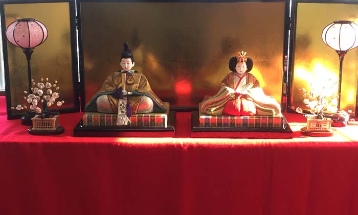 A hina doll dislay always has the emperor and empress on top with the rest of the court placed on tiers below the royals.
